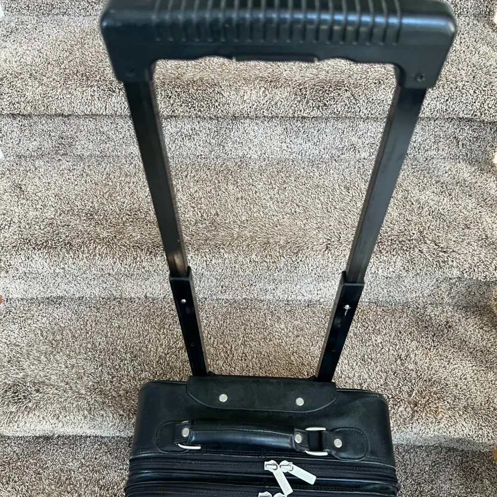Wilson’s Black Leather Carry on Luggage.